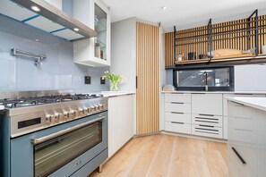 A modern kitchen with a built-in stove, oven, and microwave. - Cest La Vie Beach Villa (St. Helena Bay)