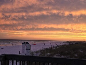 A beach with a wooden boardwalk and a signpost with safety tips. - Cozy 2-bedroom beach condo on fabulous Okaloosa Island (Fort Walton Beach)