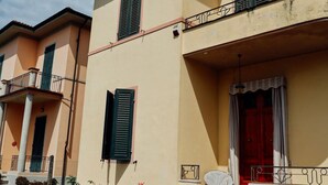 A building with balconies, a red door, and a window with shutters. - Villa Lilly, a short walk from the historic center of Lucca (Lucca)