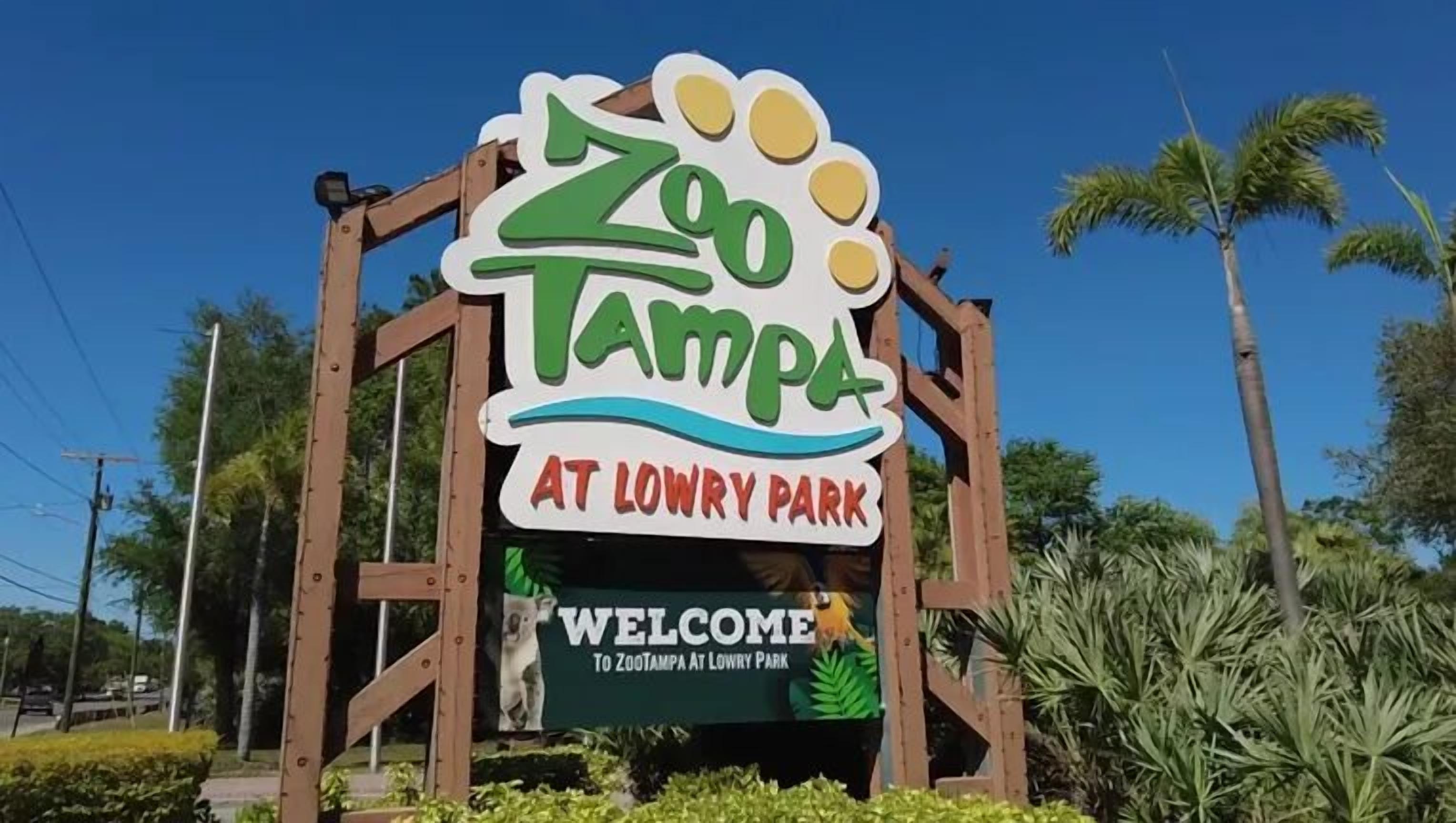 A sign for Zoo Tampa at Lowry Park with a welcoming message.