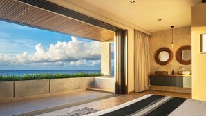A modern bedroom with a large window, a bathtub, and a view of the sea. - Valina (Tulsayab)