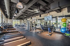 A gym with treadmills, weight machines, and exercise balls. - Sleeps 22•Pvt pool & spa•Game room (Kissimmee)