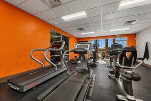 A gym with treadmills, elliptical machines, and weight equipment. - Themed rooms • Pvt pool • BBQ • Near Disney (Kissimmee)