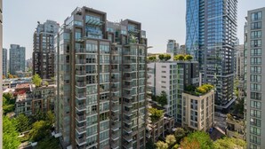A high-rise residential building with multiple balconies, large windows, and a modern architectural design.
