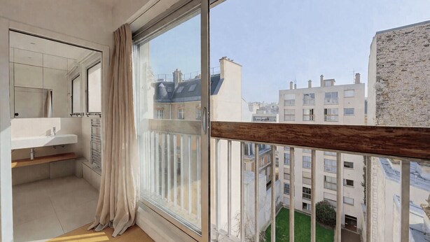 A balcony with a view of city buildings, a white sink, and a wooden shelf. - Cocoon with Eiffel Tower view (Paris)