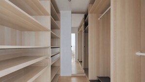 A narrow hallway with wooden shelving units on both sides and a central white pillar. - Cocoon with Eiffel Tower view (Paris)
