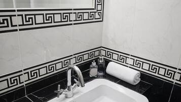 Kolmen hengen deluxe-huone, parveke, merinäköala | Kylpyhuone | Ilmaiset hygieniatuotteet, hiustenkuivaaja, pyyhkeet, saippua