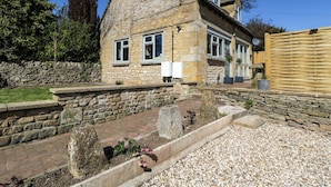 A stone house with a brick pathway, a stone wall, and a wooden fence. - Paddock View (Cheltenham)