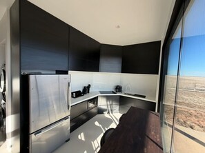 Fridge, stovetop, dishwasher, coffee/tea maker