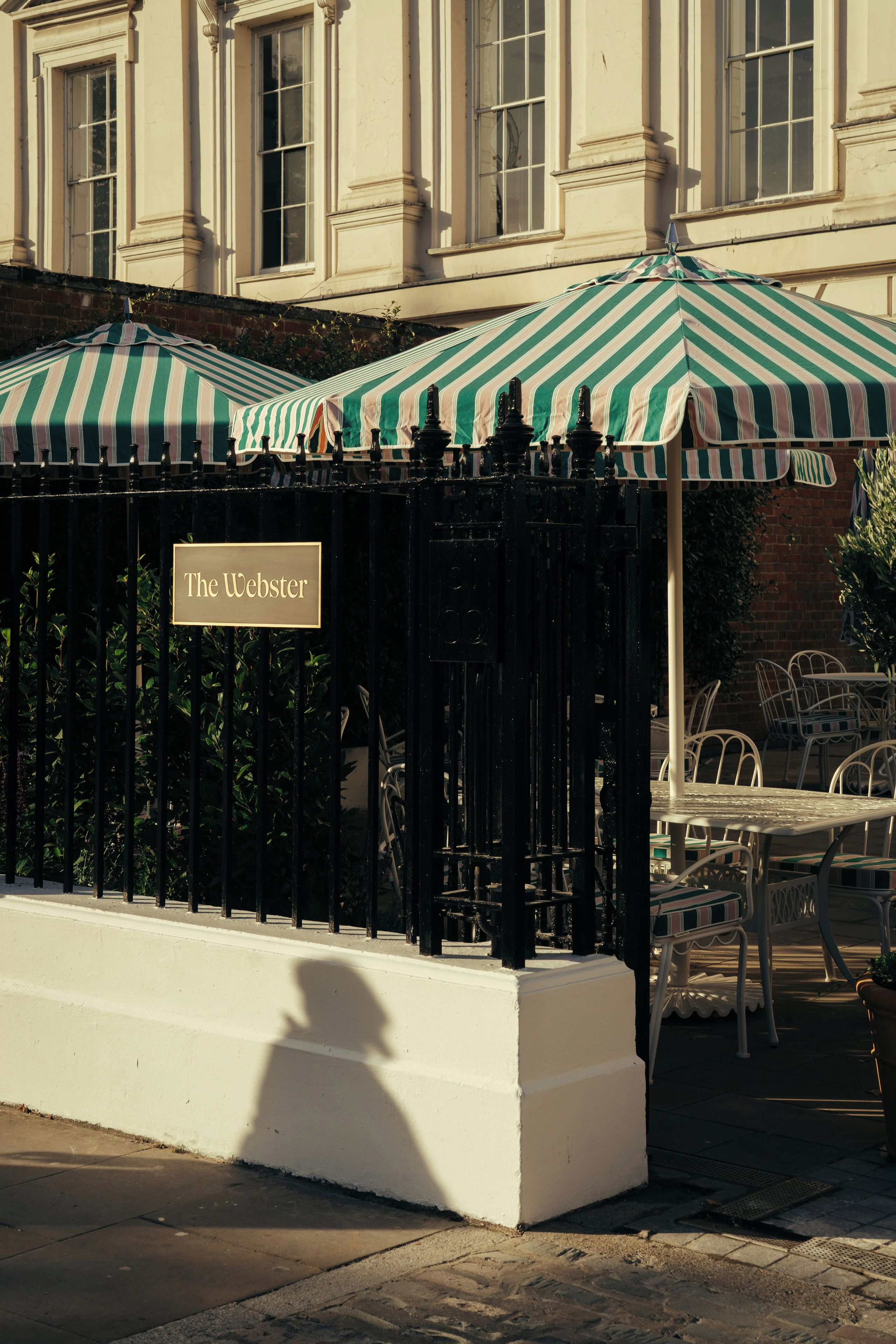 A covered outdoor seating area with a sign reading 'The Webster'.