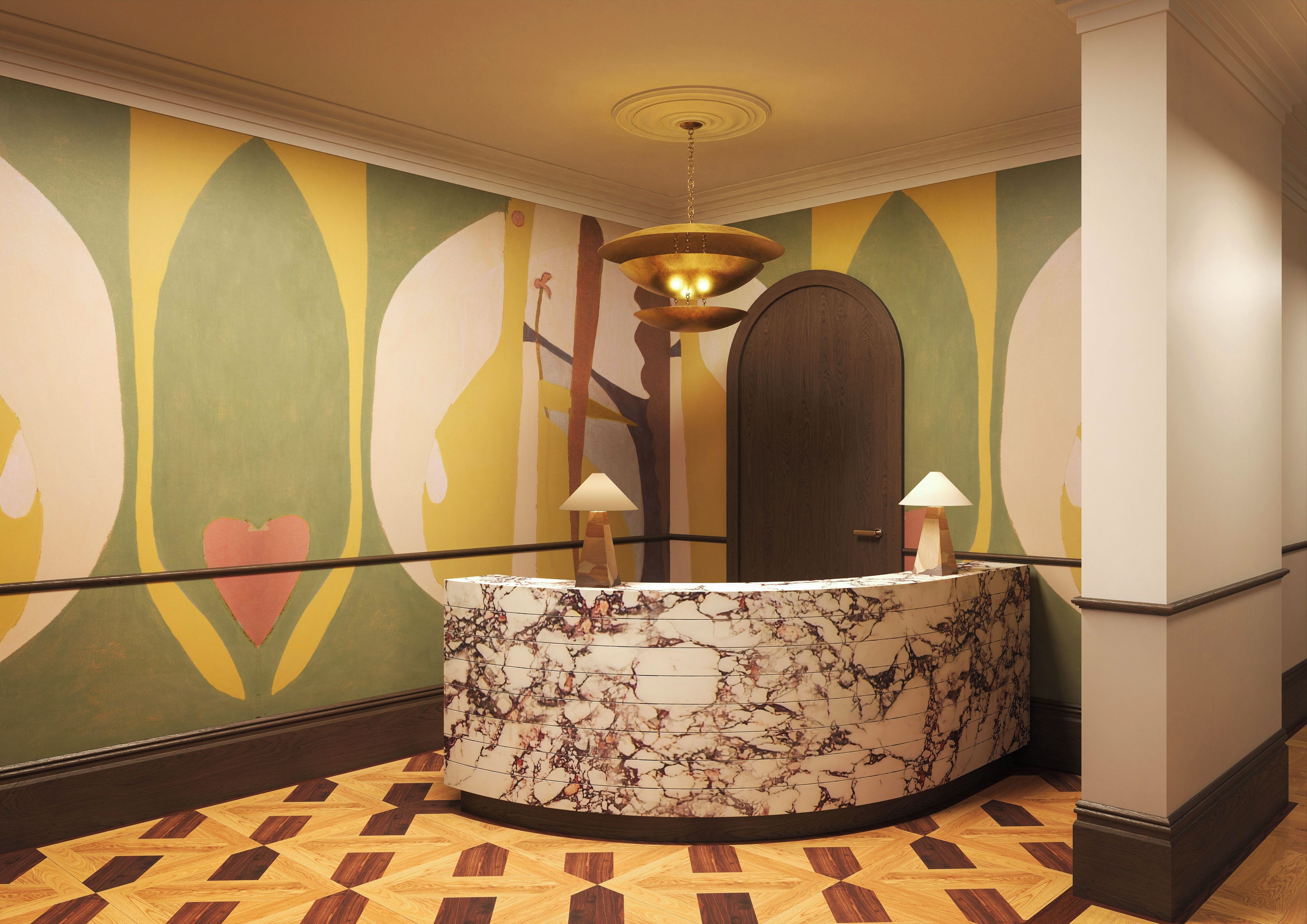 A reception area with a marble counter, a wooden door, and a colorful wall mural.