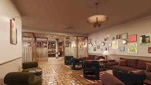 A spacious lobby with a bar area, multiple seating options, and a variety of wall art.