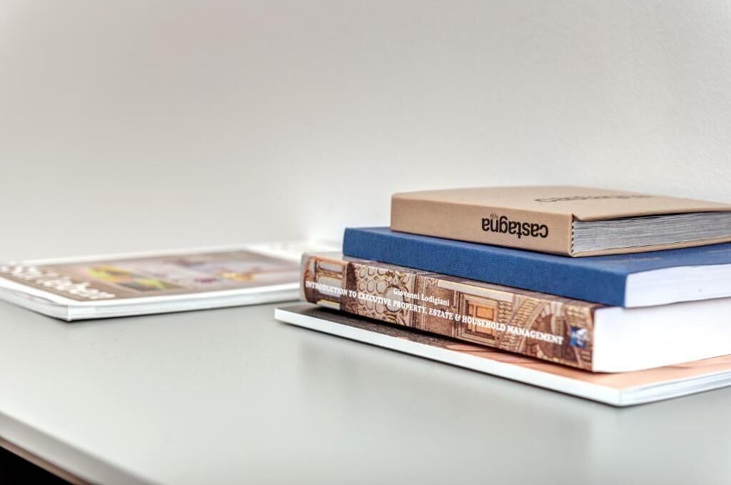 A stack of books on a flat surface.