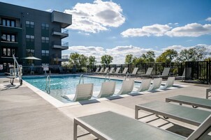 Una piscina al aire libre de temporada, sillones reclinables de piscina