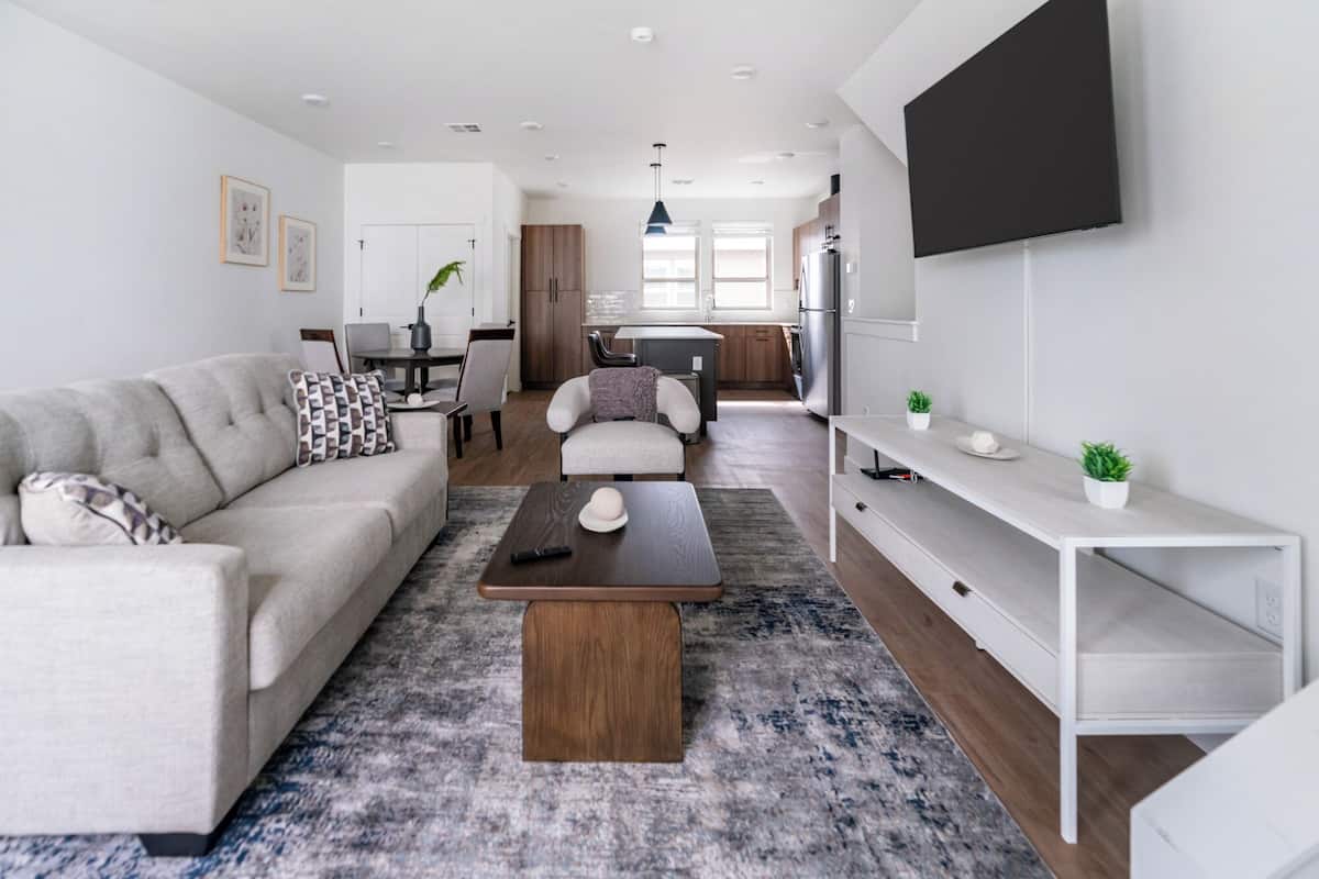 A modern living room with a sofa, coffee table, and TV.