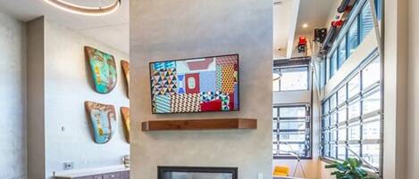 A modern lobby with a fireplace, seating area, and artwork on the walls.