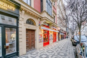 Vista da rua com um edifício que inclui um estúdio de terapia e um restaurante chamado Gorjan Bregovic.