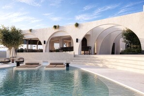 A pool area with lounge chairs and a clear sky. - Mamay Hotel (Santorini)