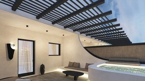 A modern interior with a curved seating area, a small pool, and a pergola structure. - Mamay Hotel (Santorini)