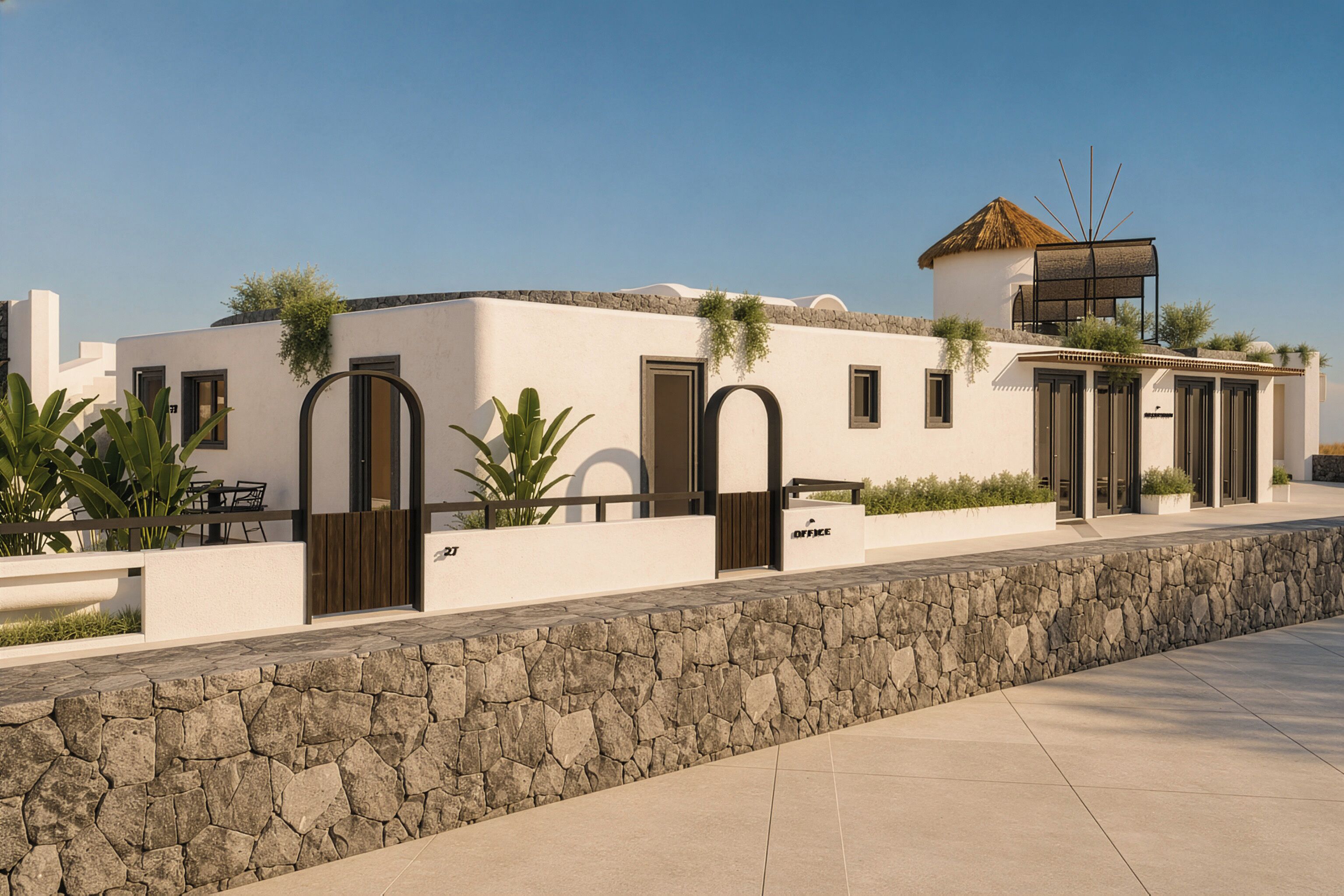 A modern building with a stone wall, a thatched-roof structure, and a series of doors and windows.