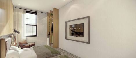 A modern hotel room with a bed, bedside table, lamp, and a framed sign on the wall.