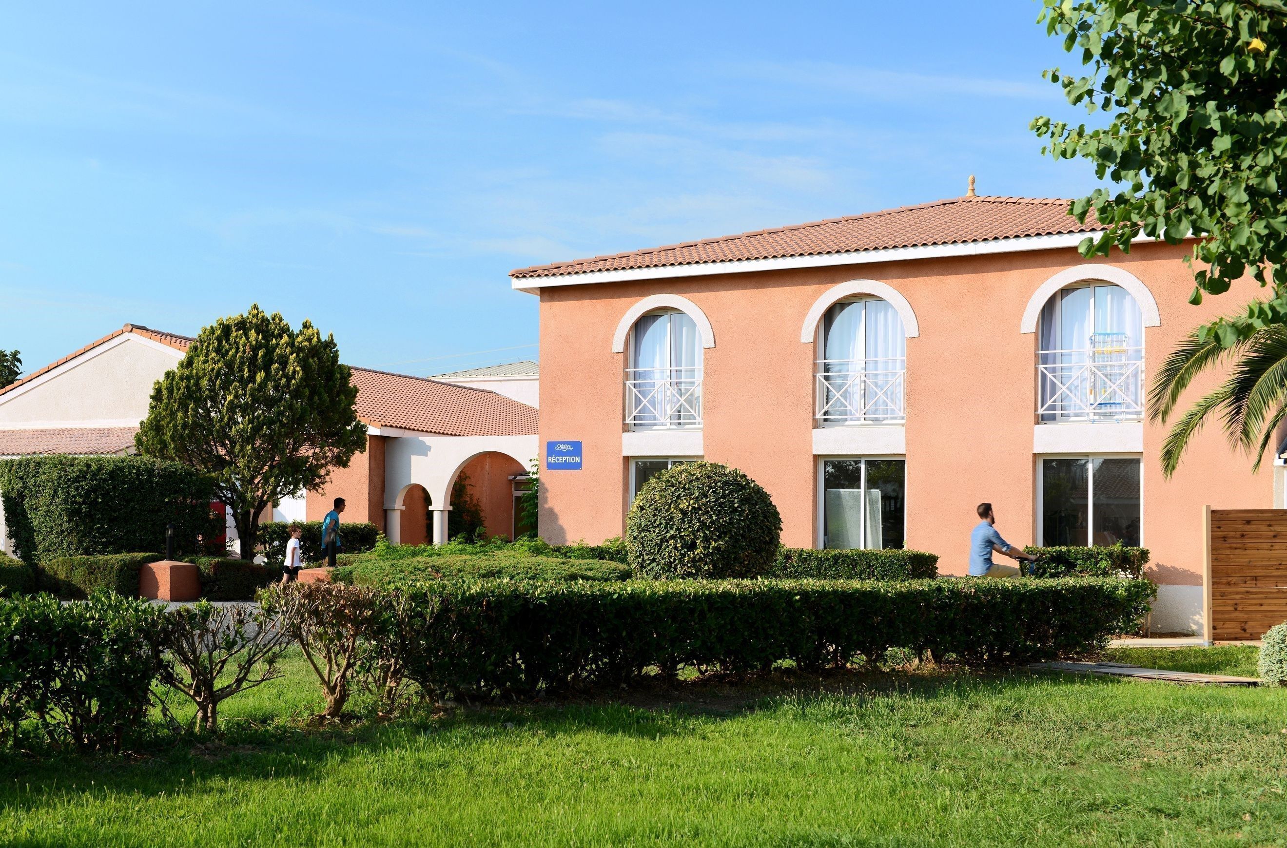 A building with a reception area, arched windows, and a tiled roof.