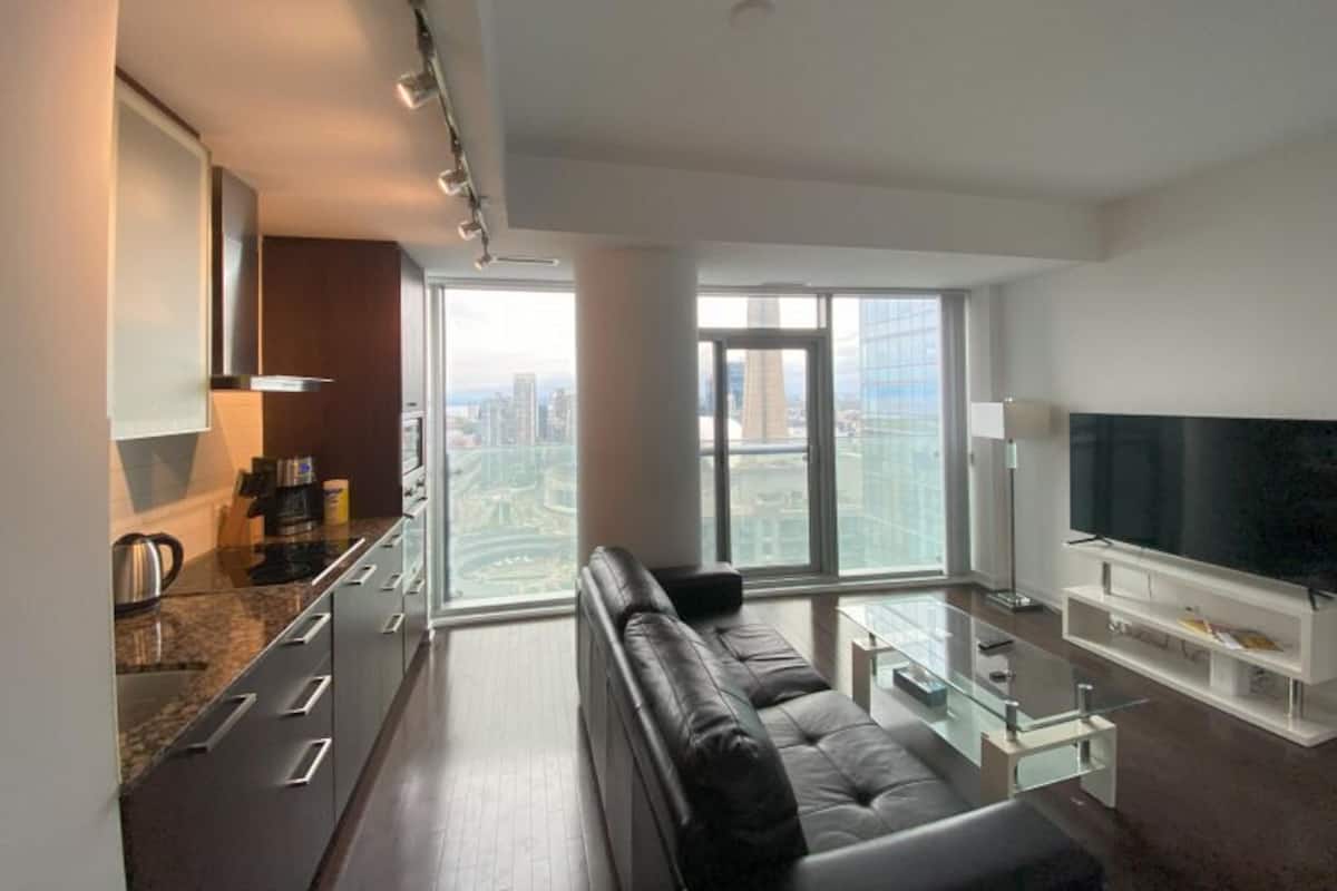 Elite Suite, 2 Bedrooms, Non Smoking | Living area | 65-inch TV with digital channels