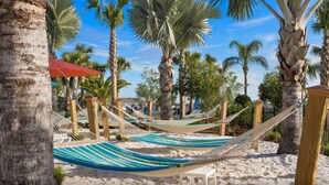 A beach area with hammocks and palm trees. - FREE Bbq+Pool Heat-8bdrm Windsor Island-Theatre/Arcade (Davenport)