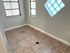 A room with two windows, a white baseboard, and a tiled floor. - Ami Lido N ~ Private home two blocks to the beach (Bradenton Beach)