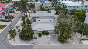 A residential area with multiple houses, a street, and palm trees. - Ami Lido N ~ Private home two blocks to the beach (Bradenton Beach)