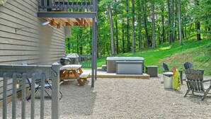 A covered outdoor patio with a grill, seating, and a hot tub. - ‘Shady Point Retreat’ w/ Hot Tub & Pickleball! (Killbuck)