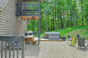 A covered outdoor patio with a grill, seating, and a hot tub. - ‘Shady Point Retreat’ w/ Hot Tub & Pickleball! (Killbuck)