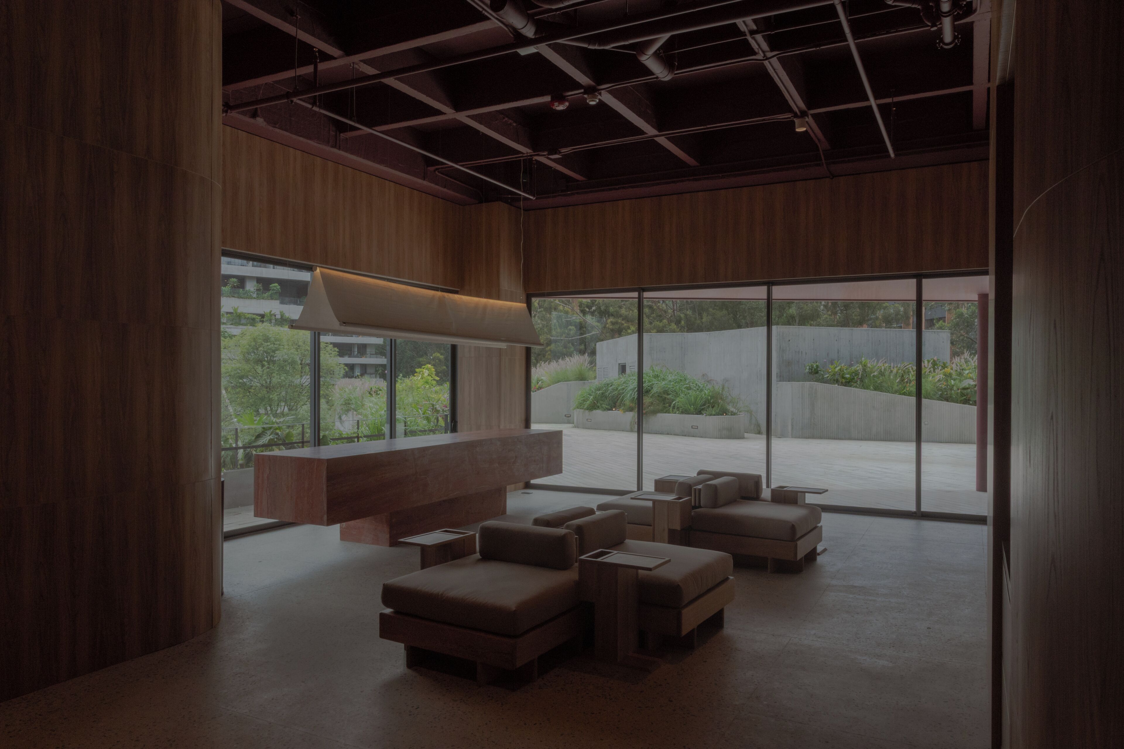 A modern interior with a large window, a bench, and a seating area.