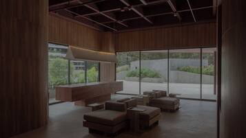 A modern interior with a large window, a bench, and a seating area.