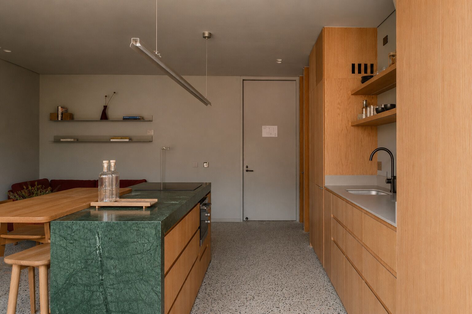 A modern kitchen with wooden cabinets, a marble countertop, and a built-in sink.