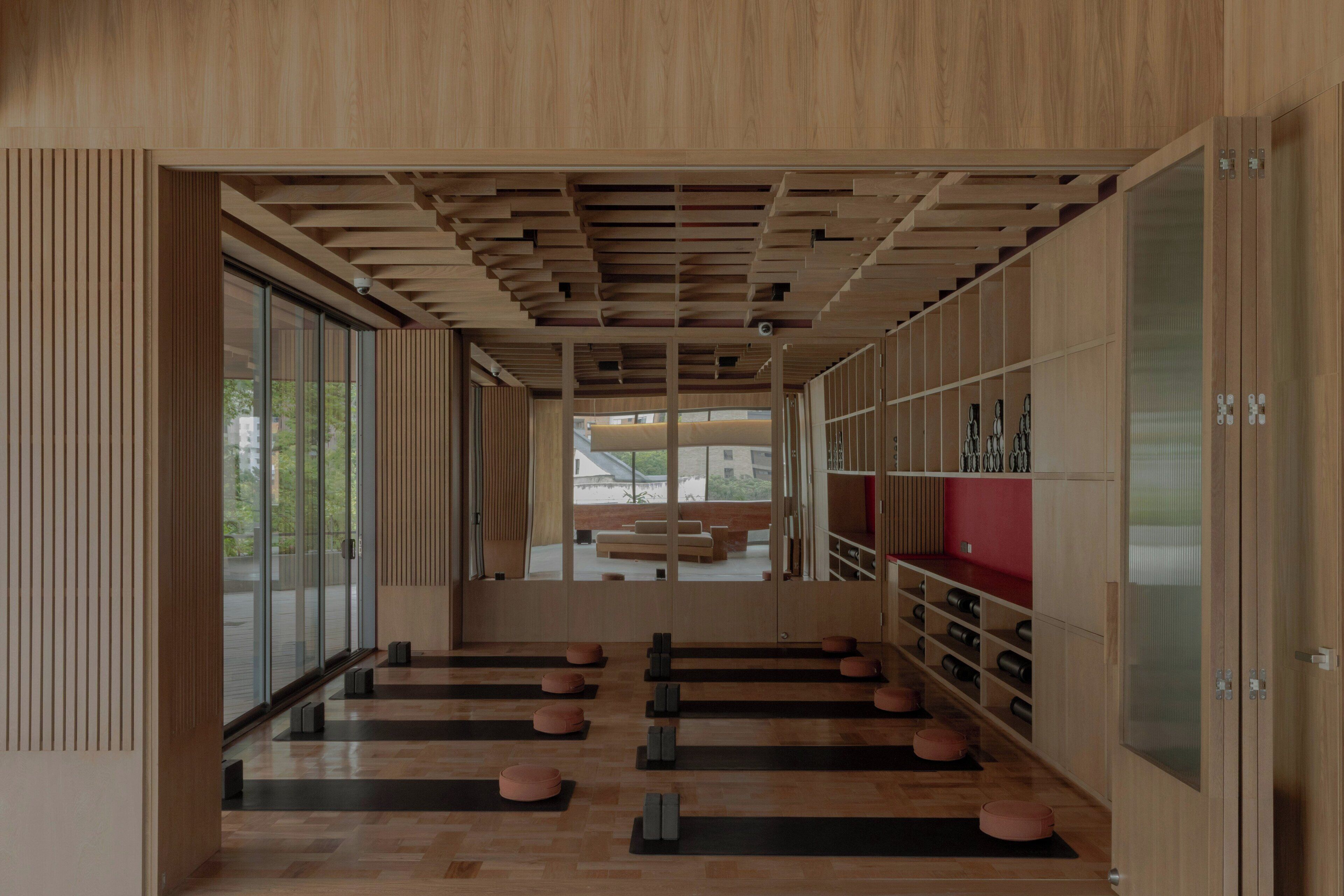 Een modern interieur met houten lambrisering, een centraal zitgedeelte en een wijnrek.