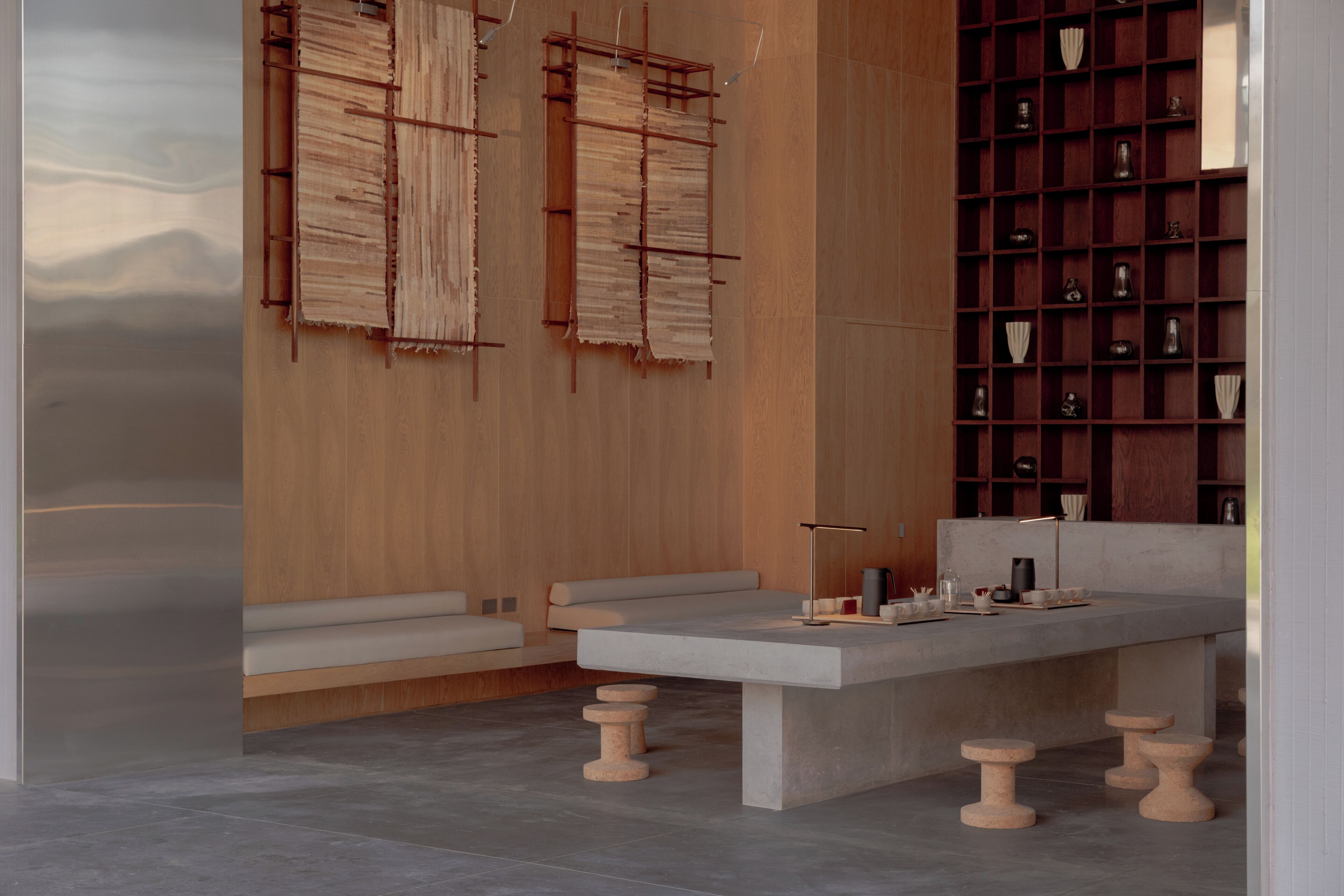 A modern interior with a seating area, a coffee table, and a bookshelf.