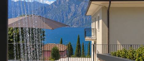 A balcony with a view of a mountain and a body of water.