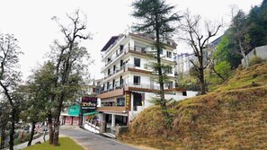 A multi-story hotel with a visible sign for 'Shiva Sanctuary'.