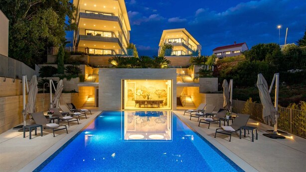 A modern hotel with a swimming pool, multiple balconies, and outdoor seating areas. - Villa Krk - Luxury apartment by the sea with view of Krk town and shared pool (Krk (Krk))