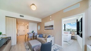 A modern apartment with a living area, dining space, and a bedroom with a city view. - Sky Corner Residence- Pool, Parking, Amenities (Miami)