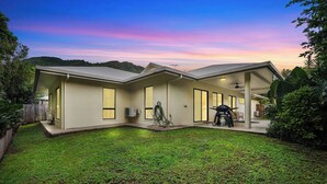 A modern two-story house with a covered patio, a small backyard, and a view of the surrounding hills. - Family Entertainer in Kanimbla - Space & Privacy (Kanimbla)