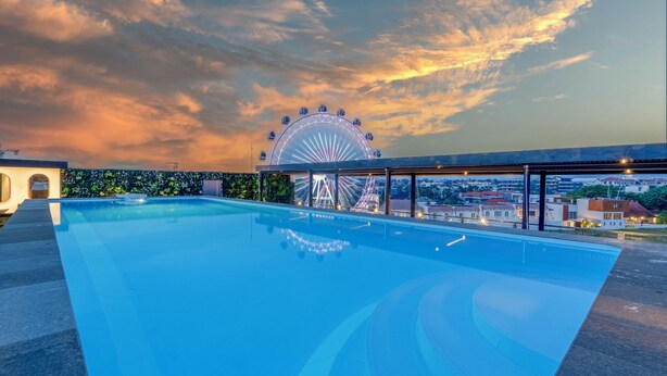 A swimming pool with a Ferris wheel in the background. - JJ JIVANA BALI (Tibubeneng)