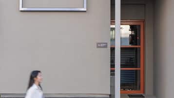 A building entrance with a door and a sign indicating the number 19.
