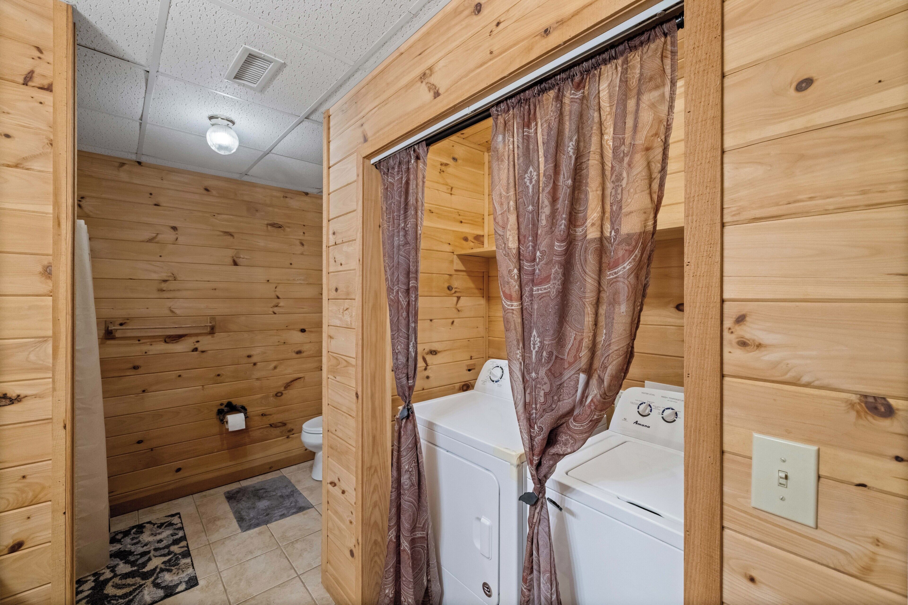 A wooden interior with a washing machine and a toilet.