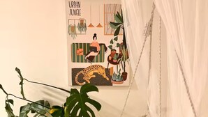 A room with a hanging chair, a suitcase, and a colorful rug. - Entire guest suite in Delta, Canada, Cozy & Stylish 1BR Perfect for Getaways (Delta)