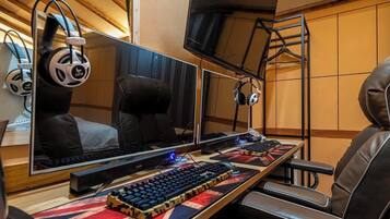 A gaming setup with multiple monitors, a mechanical keyboard, and headphones.
