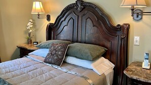A neatly made bed with a wooden headboard, two bedside lamps, and a bedside table with a phone. - Pristine 3 Bedroom, Walk-to Gt Barrington Center! (Great Barrington)