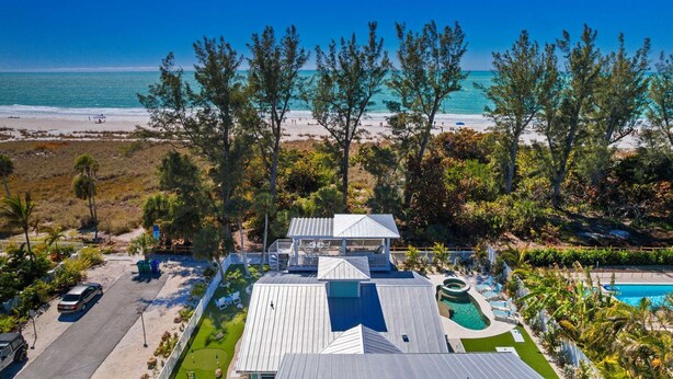 A beachfront property with a pool, a gazebo, and a view of the ocean. - A Perfect Day: Gulf Front! Rooftop Deck, Putt Putt, Pool Spa by Anna Maria Life (Anna Maria)