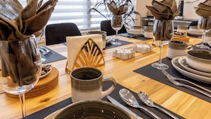 A dining table set with plates, cutlery, a coffee mug, and napkins. - King’s Gate
Fall Special • Old Town • 6 Parking • 4 King Beds (Niagara-on-the-Lake)